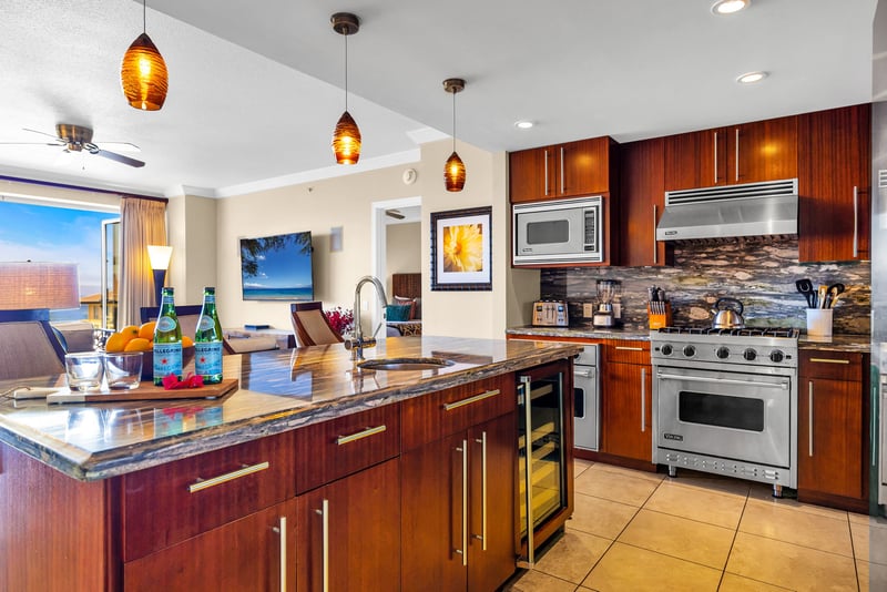Full kitchen with granite counters, stainless appliances, and bar seating for casual dining.