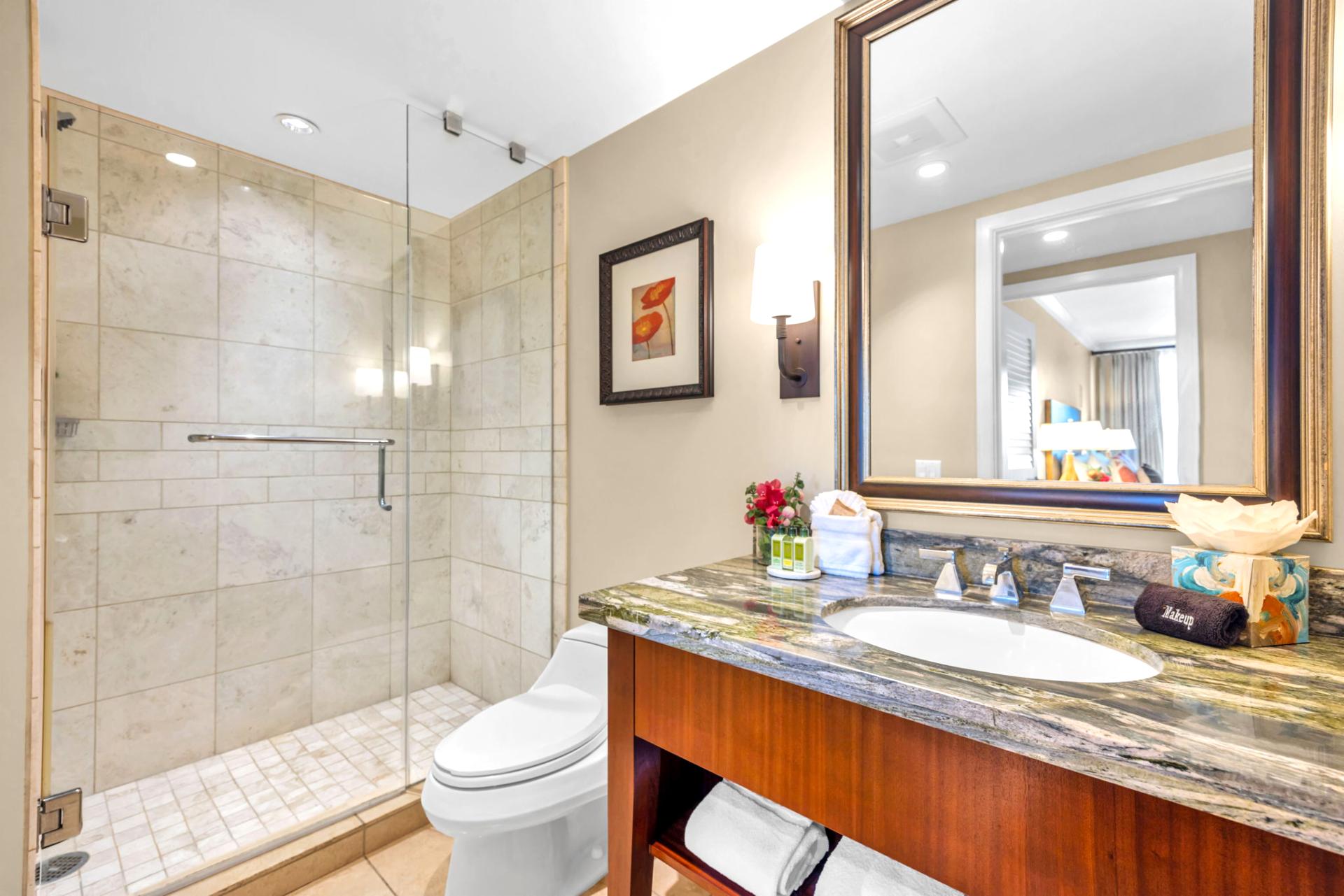 Ensuite bath with walk-in shower and granite vanity for a polished finish.