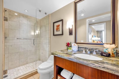 Ensuite bath with walk-in shower and granite vanity for a polished finish.
