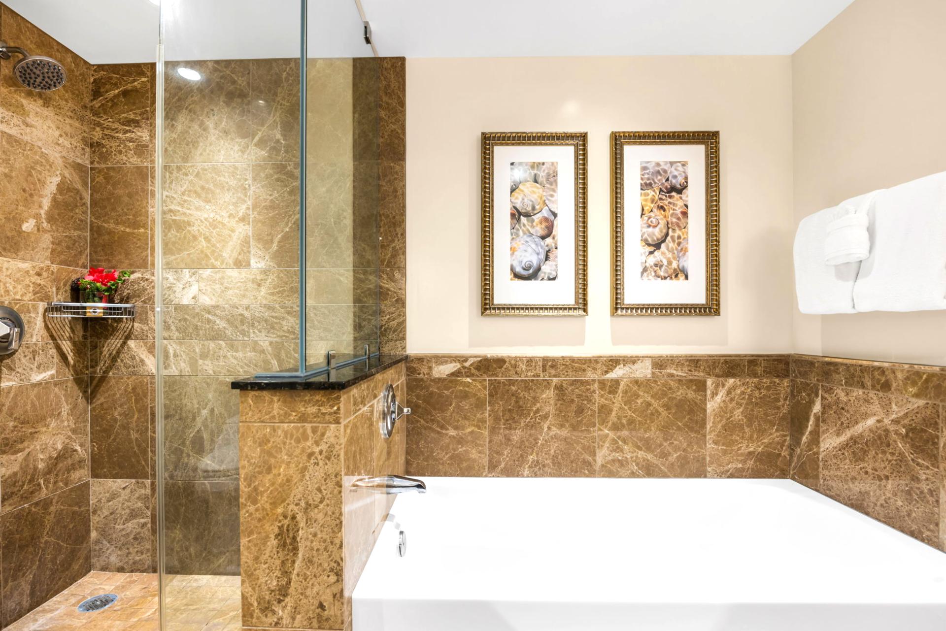 Deep soaking tub and stone surround add a touch of luxury to the guest bath.