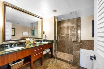 Guest bathroom with granite counters and walk-in shower for convenience. HKK-825
