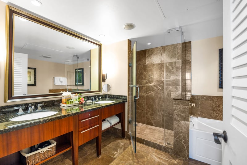 Guest bathroom with granite counters and walk-in shower for convenience.