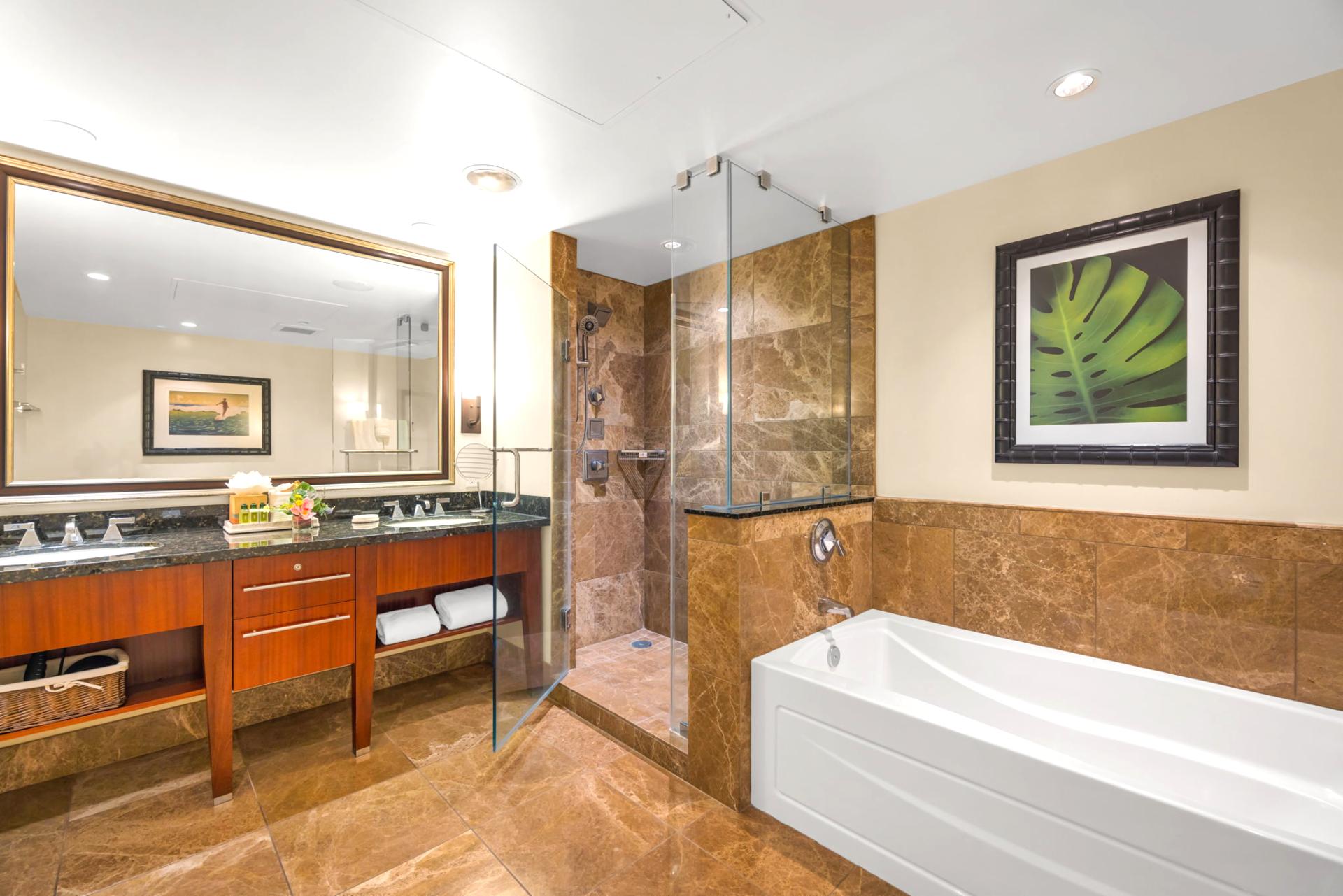 Granite vanity and deep soaking tub in the guest bath offer spa-like comfort.