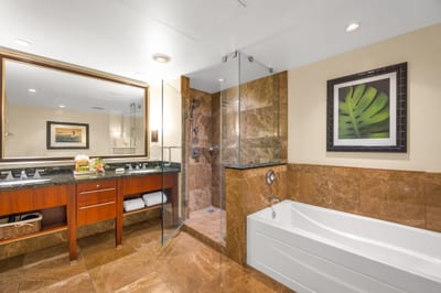 Granite vanity and deep soaking tub in the guest bath offer spa-like comfort. HKK-825