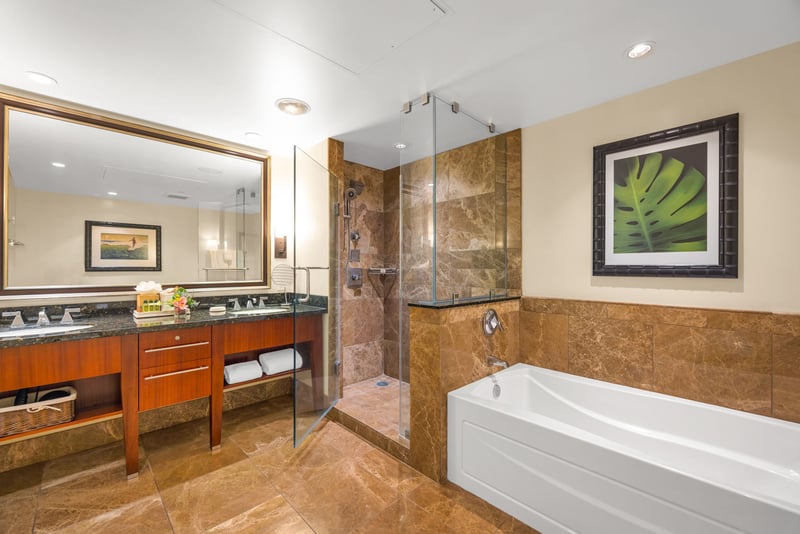 Granite vanity and deep soaking tub in the guest bath offer spa-like comfort.