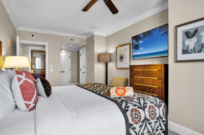 King bed and accent chair in a calm, coastal-inspired guest bedroom. HKK-825