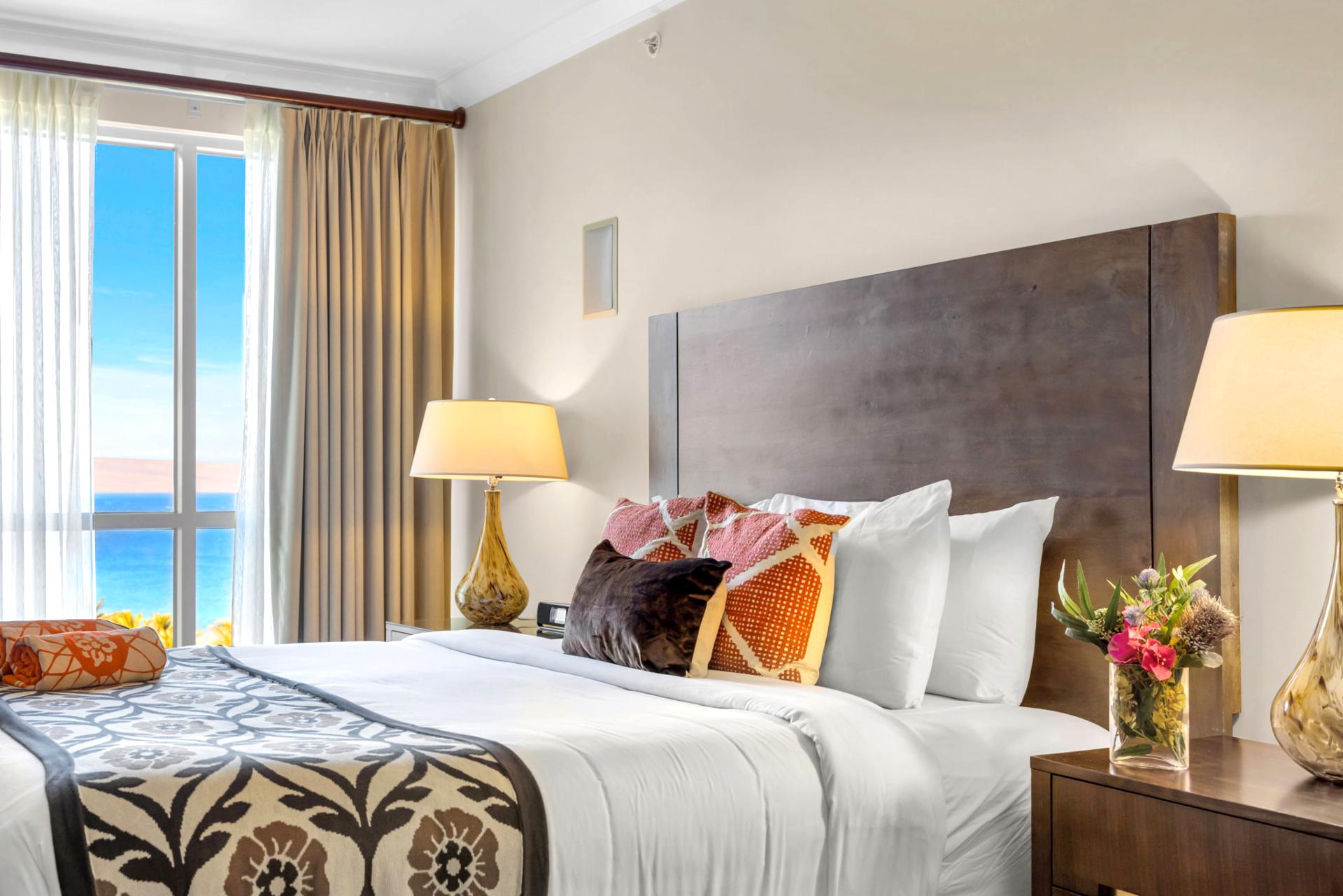 Bright and welcoming guest room with King bed and tropical views.