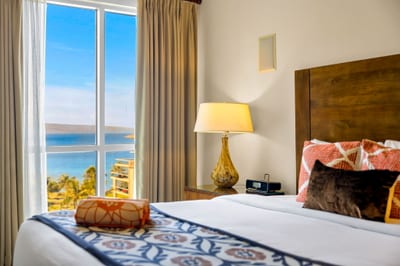 King guest bedroom with colorful island touches and ocean-facing window. HKK-825