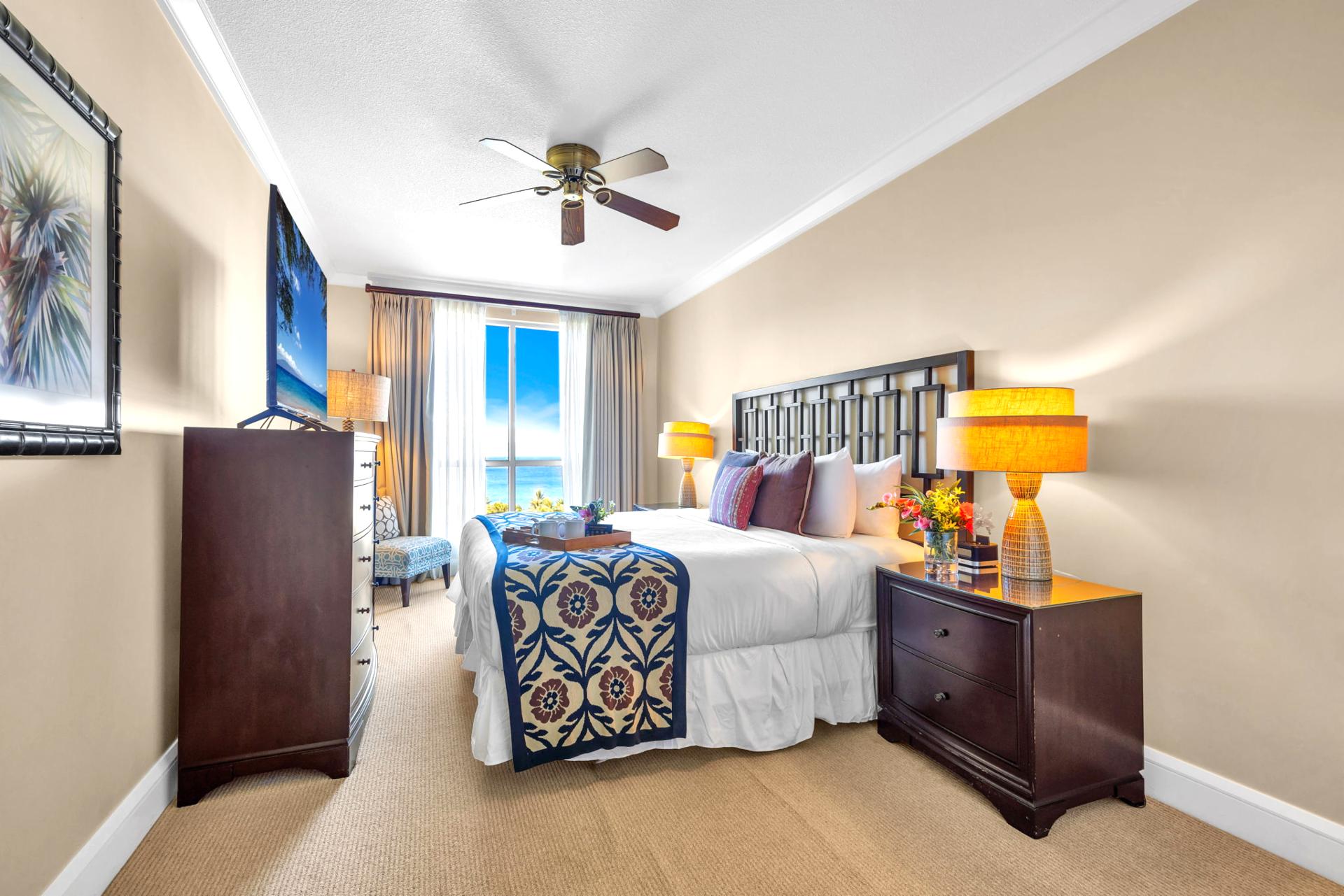 King bed with padded headboard and ensuite access in a serene and private setting.