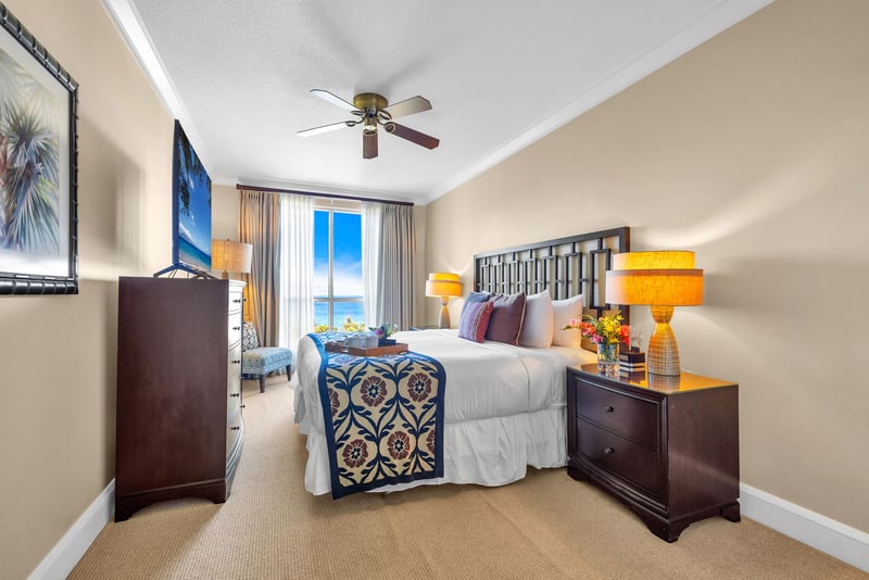 King bed with padded headboard and ensuite access in a serene and private setting.