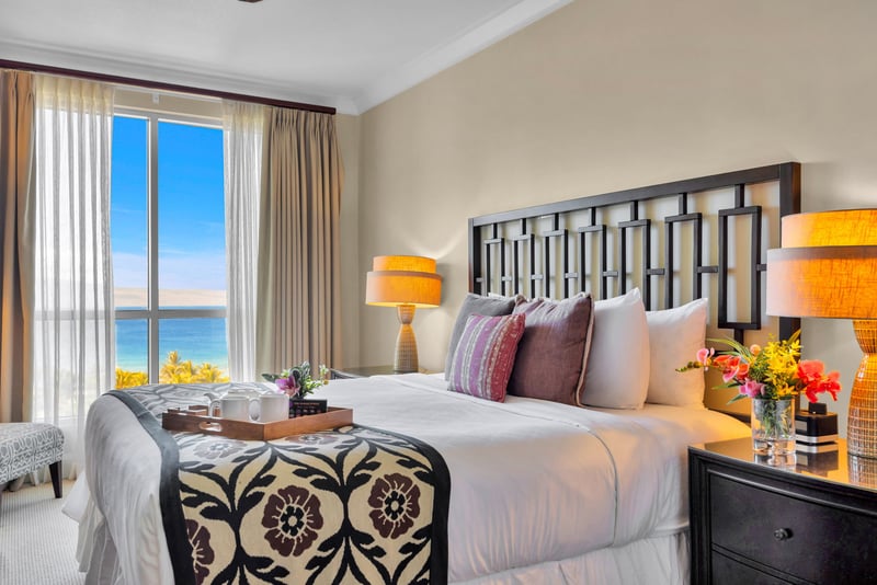Serene King bedroom with neutral tones and warm lighting for restful nights.