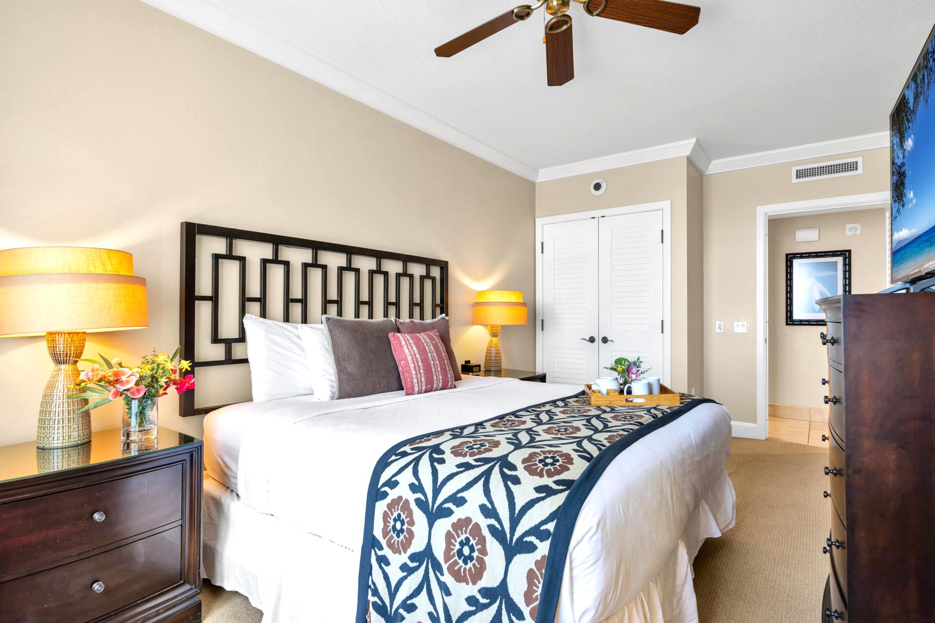 Spacious King bedroom with Smart TV and calming natural light.