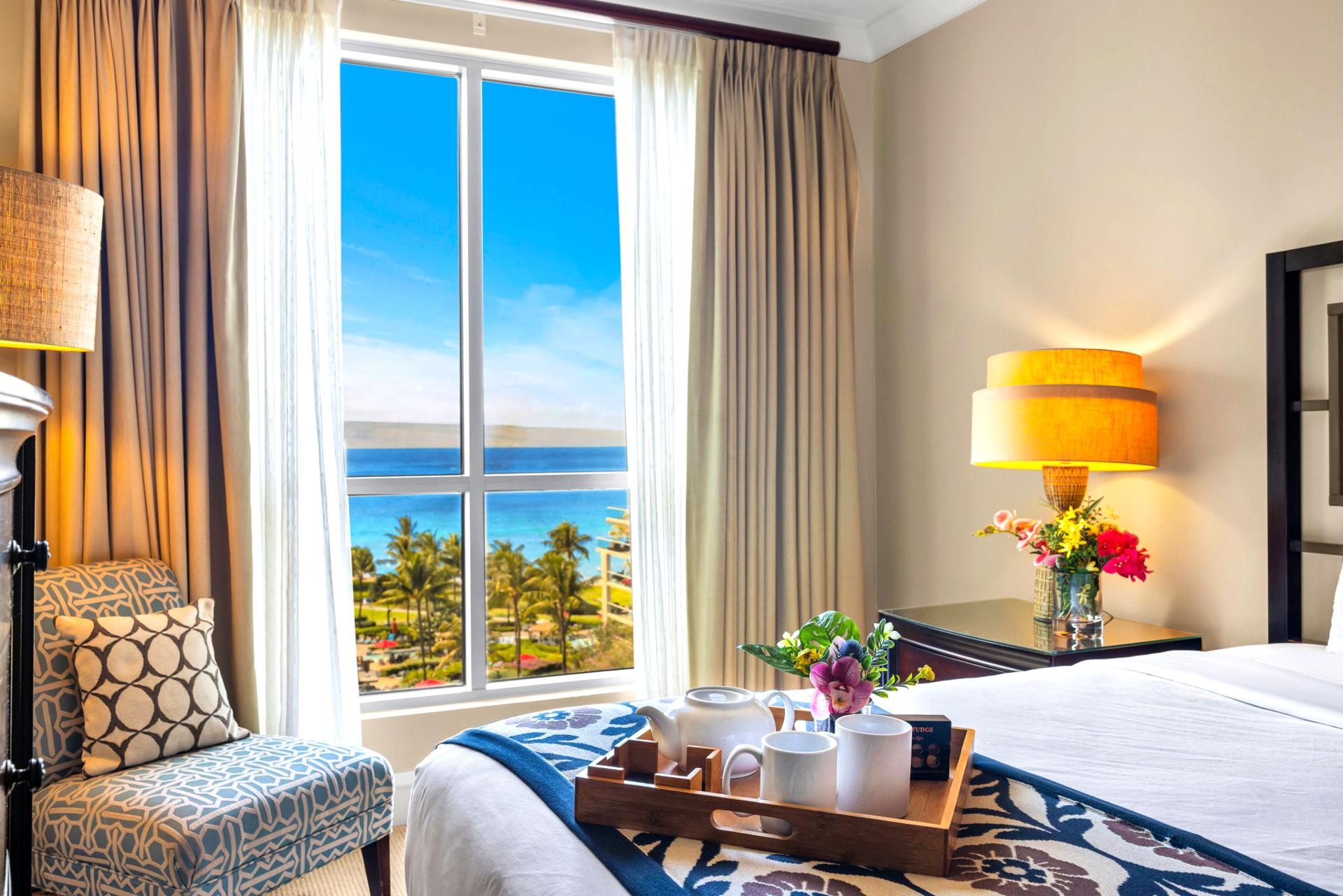 King primary suite with ocean glimpses and ensuite access for added comfort.