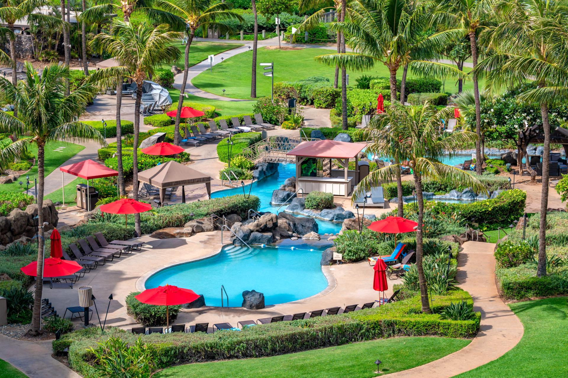 Lounge poolside beneath red umbrellas or float along the lazy river-style stream at Honua Kai, all surrounded by tropical gardens just moments from the beach.