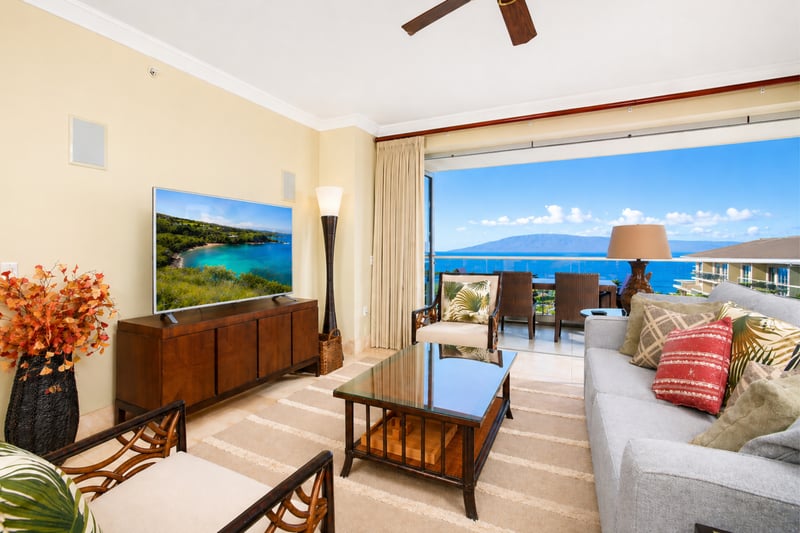 Inside, your living area opens wide to the lanai, blending indoor comfort with outdoor scenery and inviting ocean breezes.