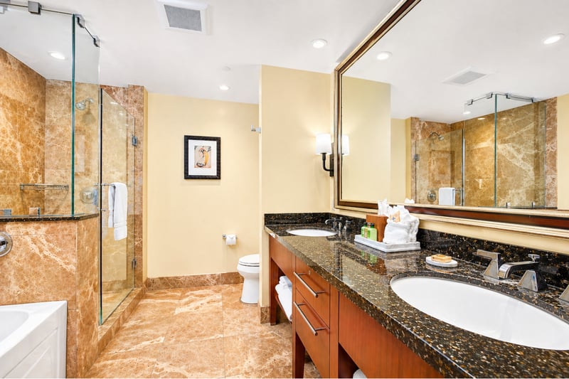 Dual vanity and granite counters provide plenty of space for getting ready, with warm finishes that enhance the spa like feel.