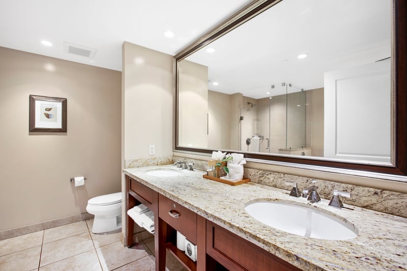 Elegant bathroom with double vanity, granite countertops, and spa shower. HKK-920