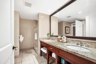 Spacious bathroom retreat with granite counters and modern glass shower.