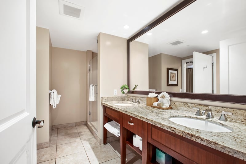 Spacious bathroom retreat with granite counters and modern glass shower.