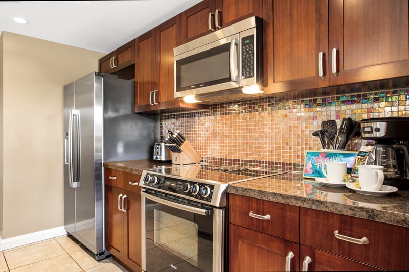 Warm-toned kitchen with modern appliances and tropical coffee station setup. HKK-920
