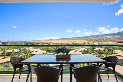 Balcony dining with panoramic mountain views and tropical rooftop scenery.