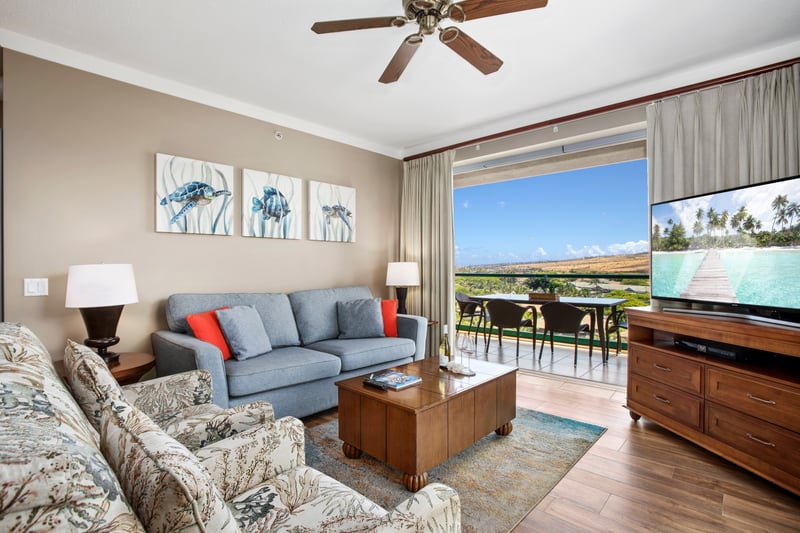 Bright island living room with balcony, ocean art, scenic views. HKK-920