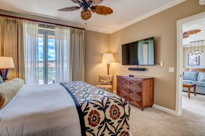 Serene bedroom retreat with mountain view and stylish island decor.