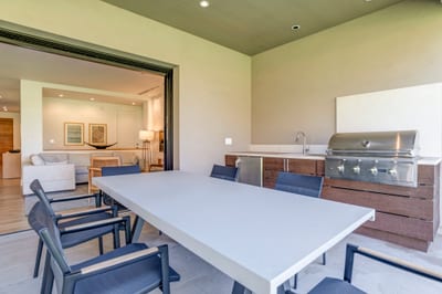 Modern outdoor kitchen and dining area with seamless indoor access
