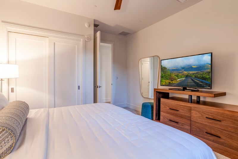 Relax in your island escape with plush bedding and sleek furnishings