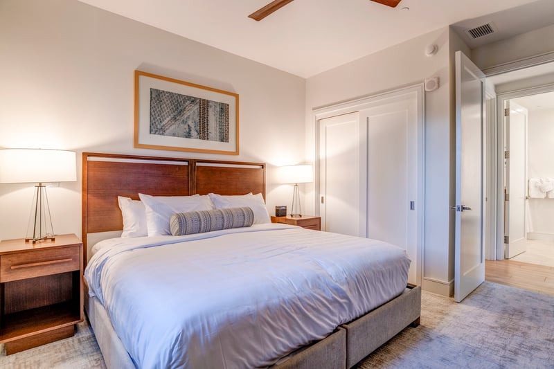 Elegant bedroom with plush bedding, wooden furniture, and warm lighting