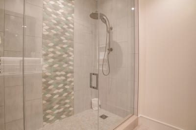 Walk-in glass shower with spa-inspired rainfall shower head