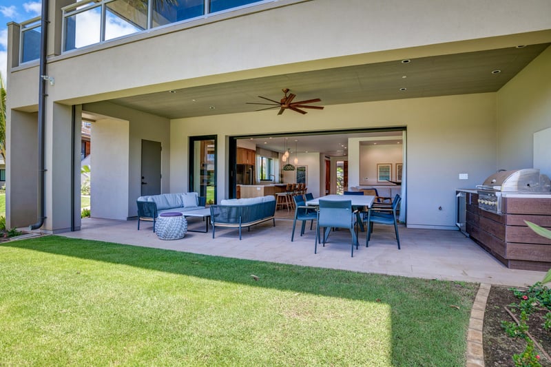 Covered lanai with BBQ, dining, lounge, and garden views