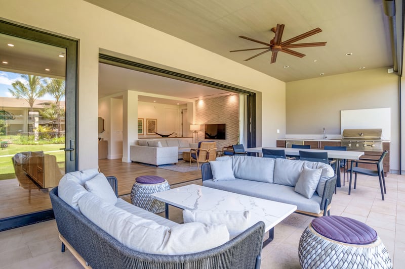 Relax under the covered lanai with outdoor sofa, coffee table, and peaceful island scenery