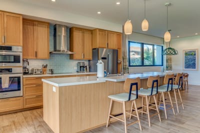 Sleek modern kitchen with island seating and ample natural light