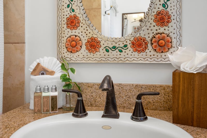 Brighten your day with hand-painted floral charm, bronze fixtures, and a cozy shower-tub that invites you to unwind