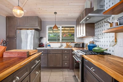 Bathed in honeyed light and framed by whispering foliage, this kitchen is a quiet symphony of nature and nurture combined