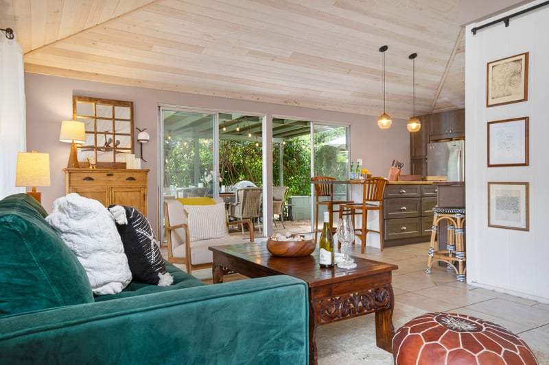 Cozy open-concept living space with rustic charm and garden view.