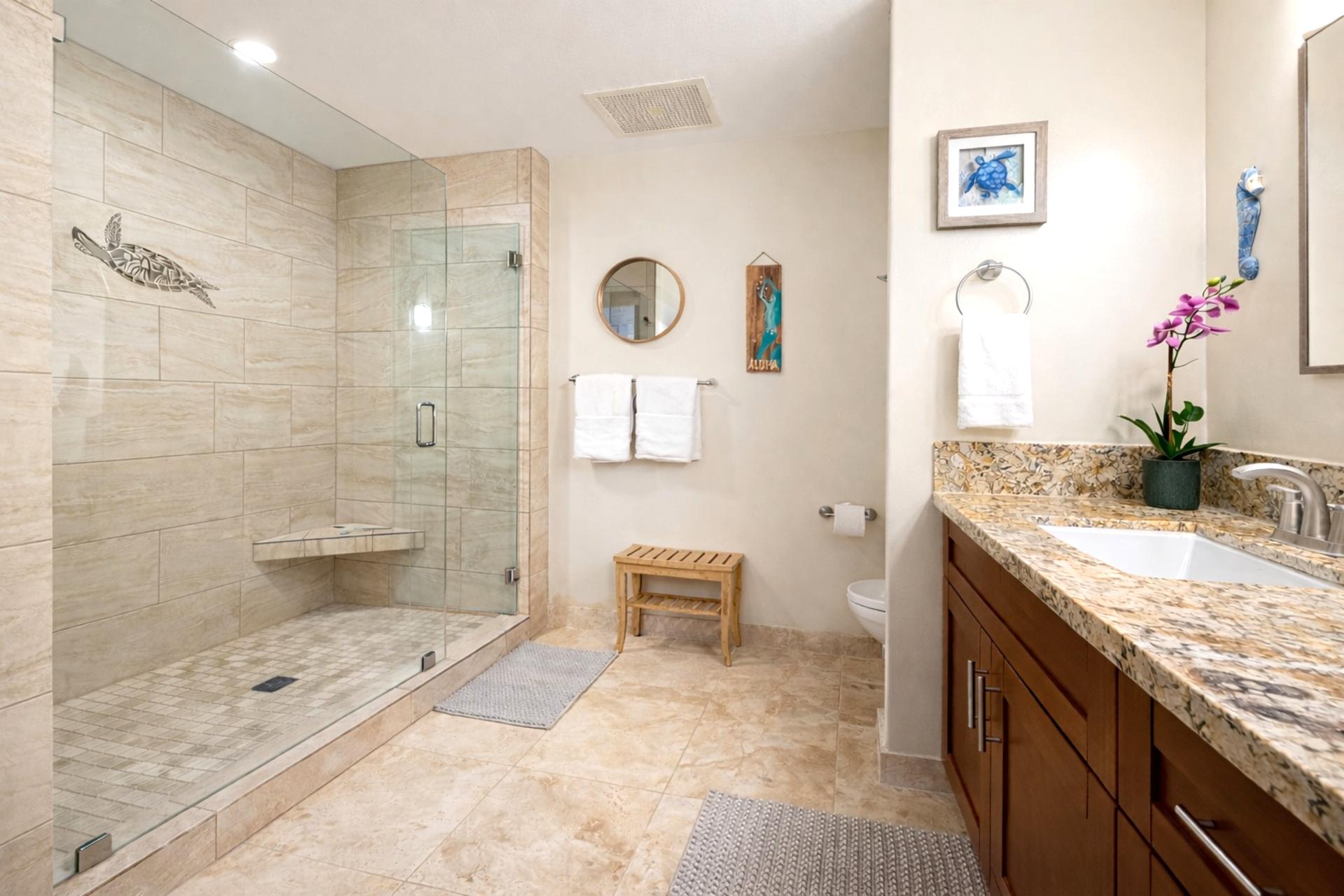 The primary bath walk in shower features decorative tile detail