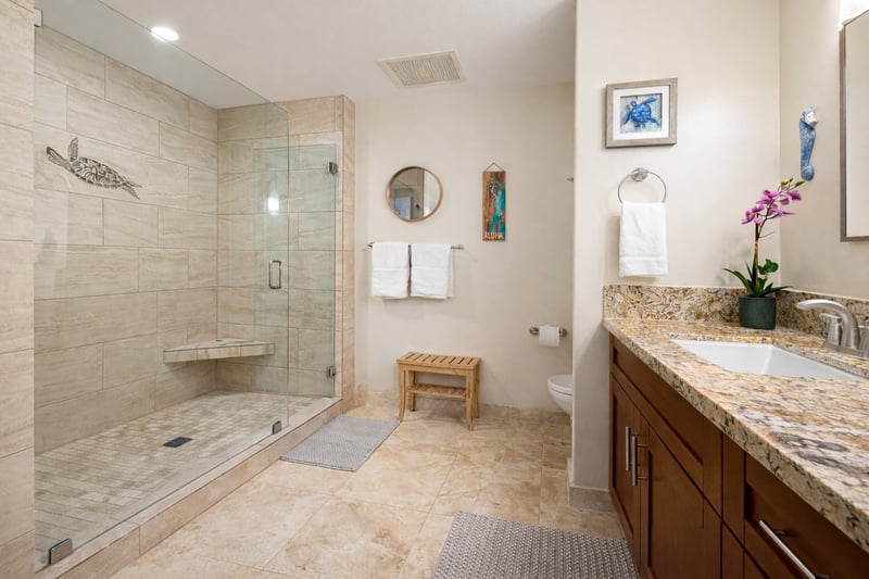 The primary bath walk in shower features decorative tile detail