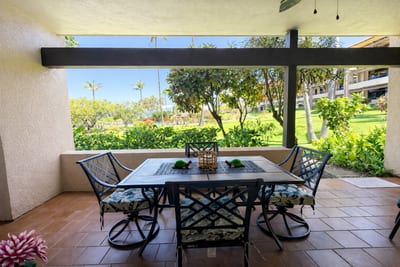 Outdoor dining table surrounded by tropical foliage