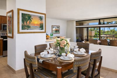 Set with woven grace, blooming florals, and soft natural light, this table invites stories, sips, and island bites