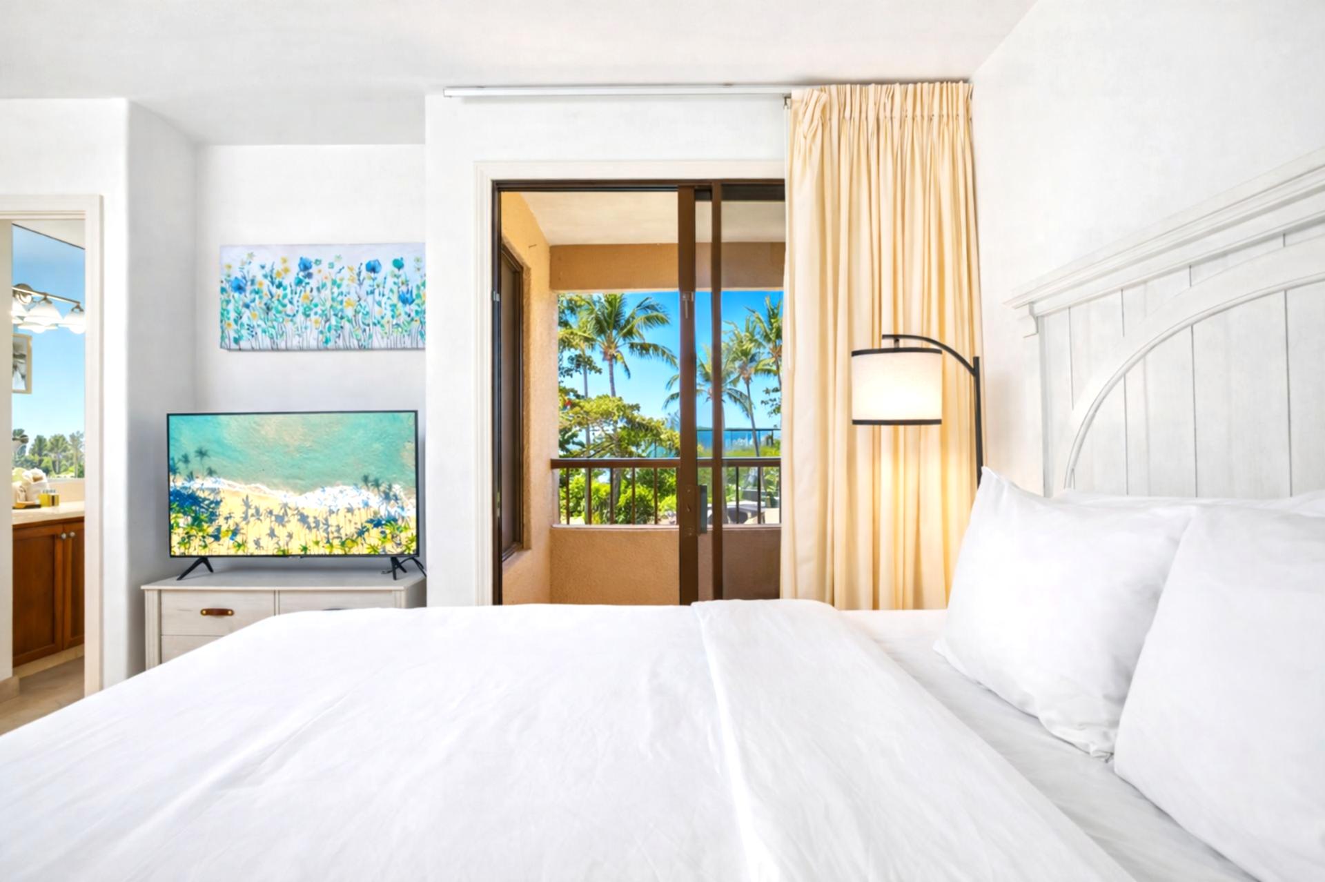 Serene and sun-drenched, this guest room offers crisp whites, a private lanai, vibrant art, and coastal charm    