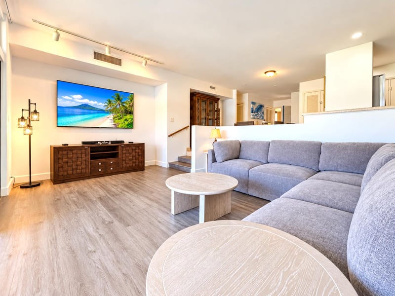 A step up and a wood display cabinet mark the transition from your living room toward the dining area and kitchen.