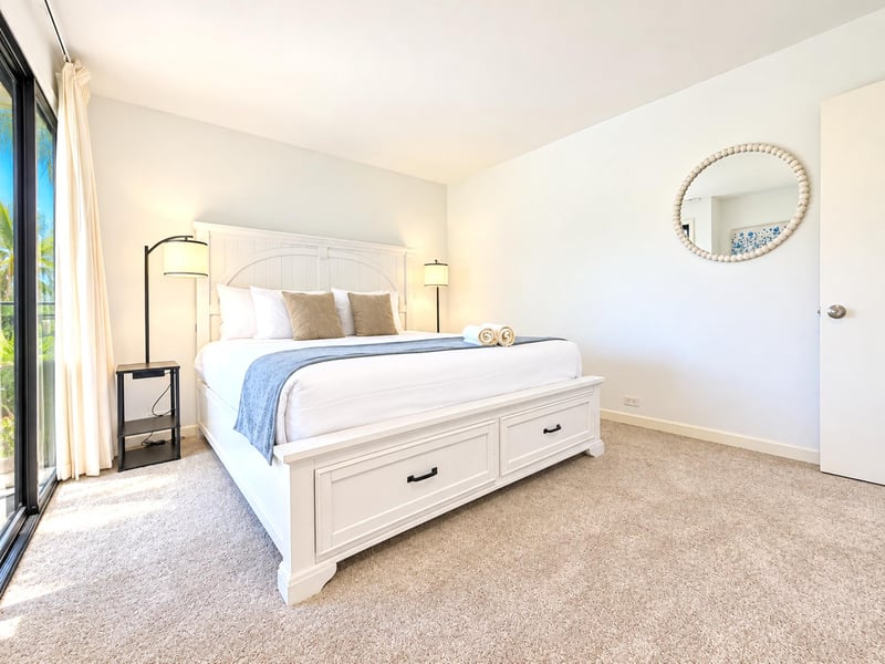 A beaded mirror, reading lamps, and sliding doors to the lanai round out your second bedroom, with curtains to soften the morning light.