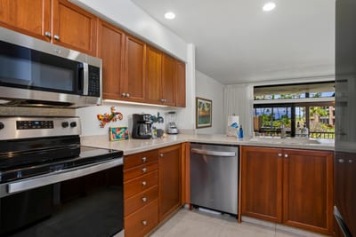 With sleek steel, warm wood, and playful island art, this kitchen invites you to stir up both flavor and fun