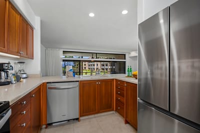 From pineapple prep to sunset snacks, this polished kitchen blends modern ease with tropical warmth and sparkle.