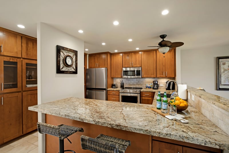 Modern gourmet kitchen with granite countertops and stainless steel appliances.
