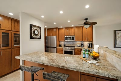 Modern gourmet kitchen with granite countertops and stainless steel appliances.