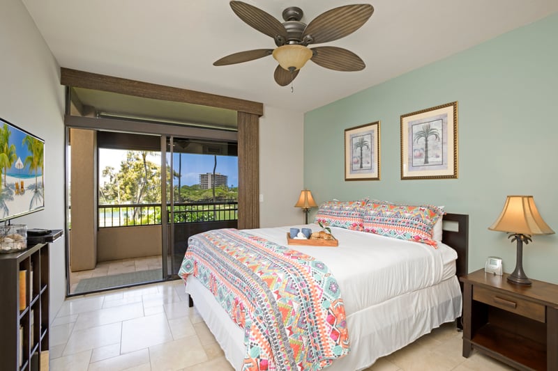 Bright bedroom retreat with tropical decor and private lanai access.