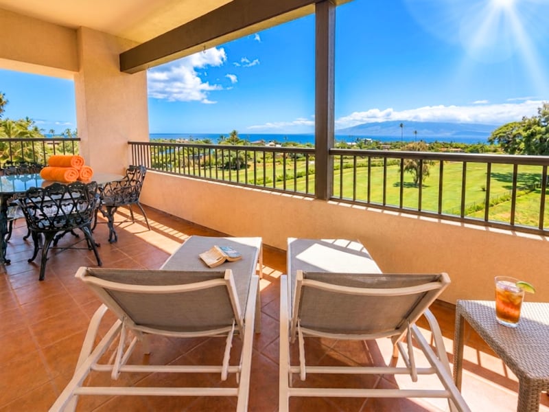Your lanai lounge chairs face open ocean views and a side table for your afternoon drink.